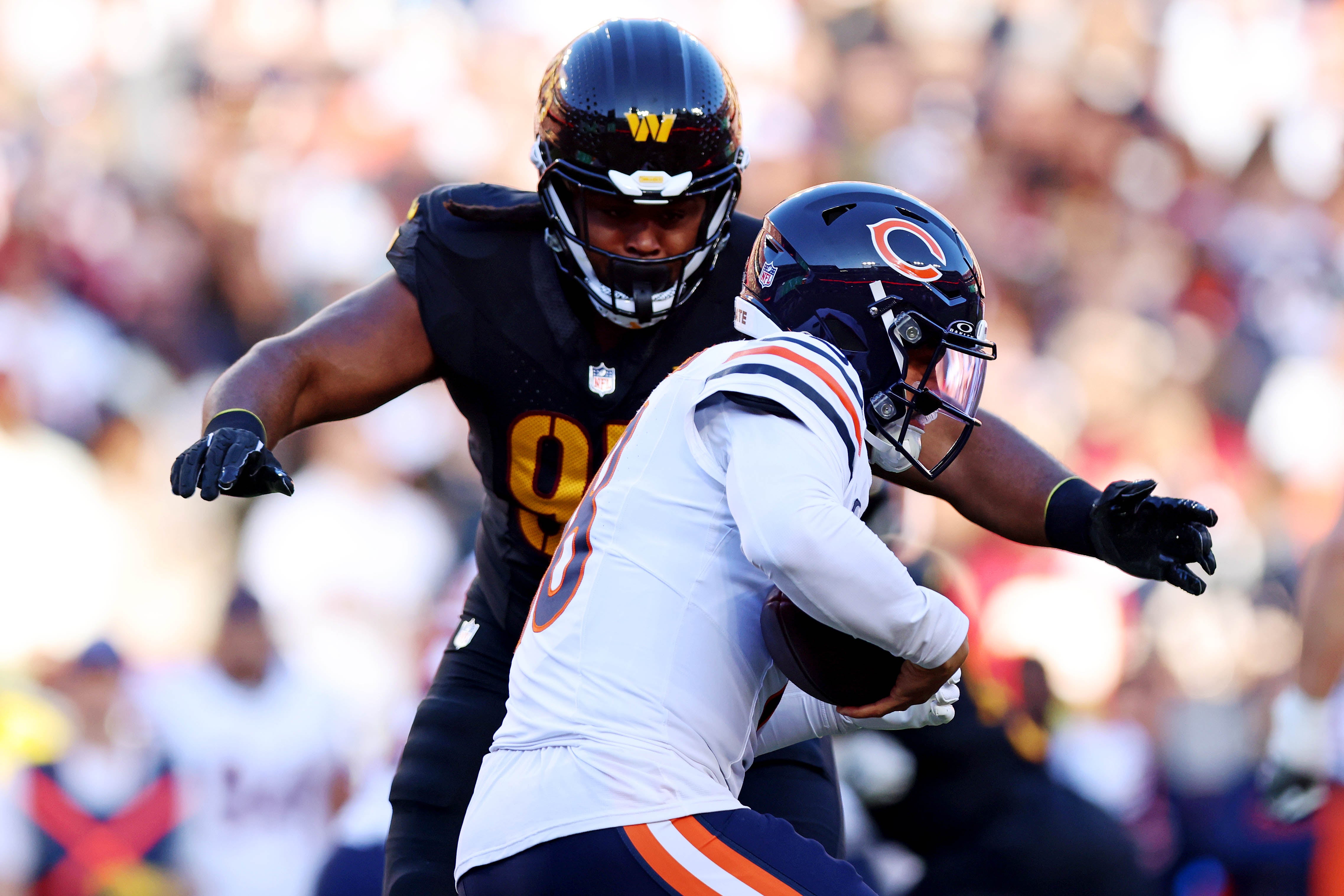 Oct 27, 2024; Landover, Maryland, USA; Chicago Bears quarterback Caleb Williams (18) is sacked by Washington Commanders defensive tackle Jer'Zhan Newton (95) during the first half at Commanders Field.