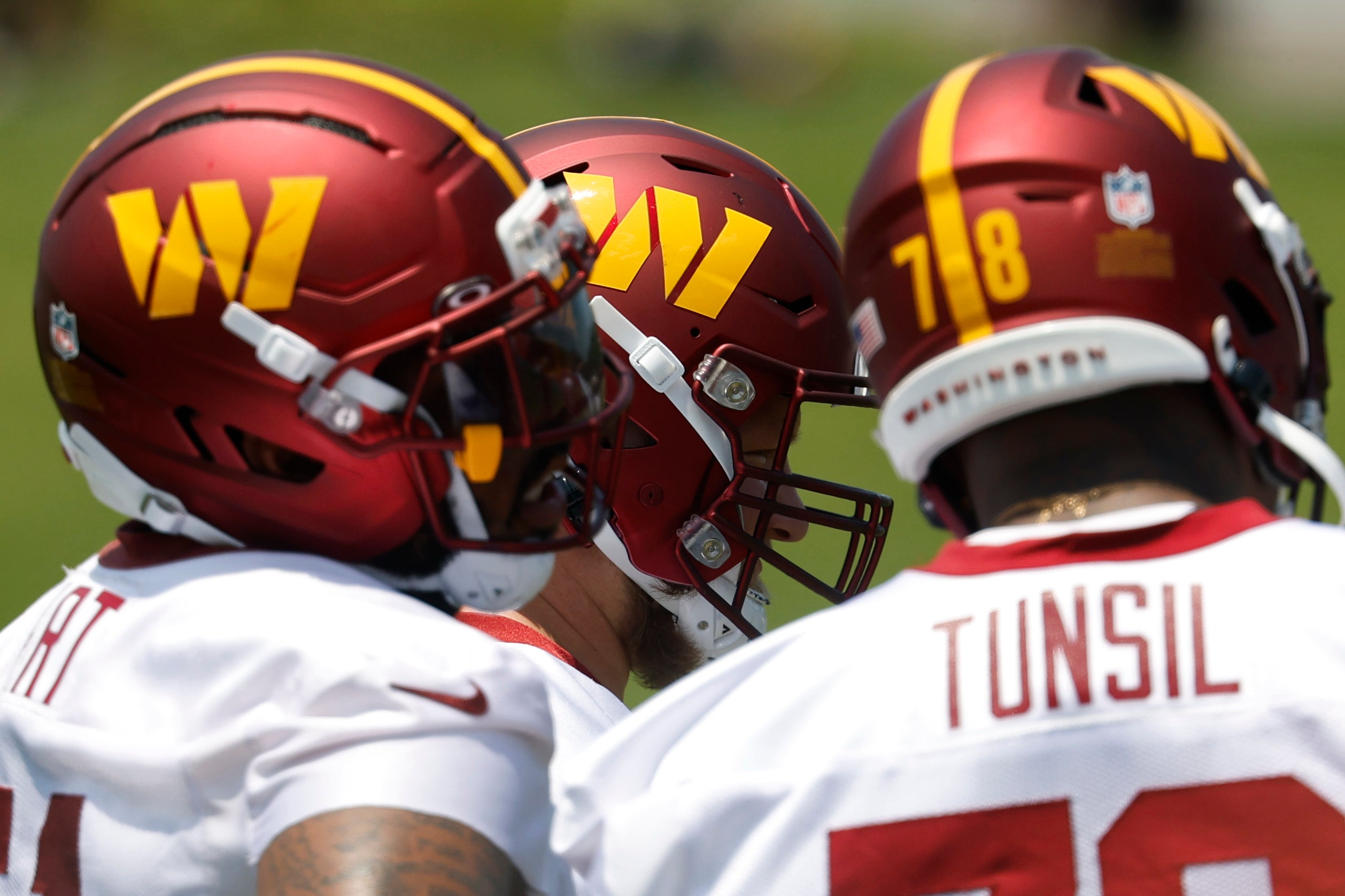Jun 10, 2025; Ashburn, VA, USA; Washington Commanders offensive linemen stand on the field between drills on day one of minicamp at Commanders Park. 