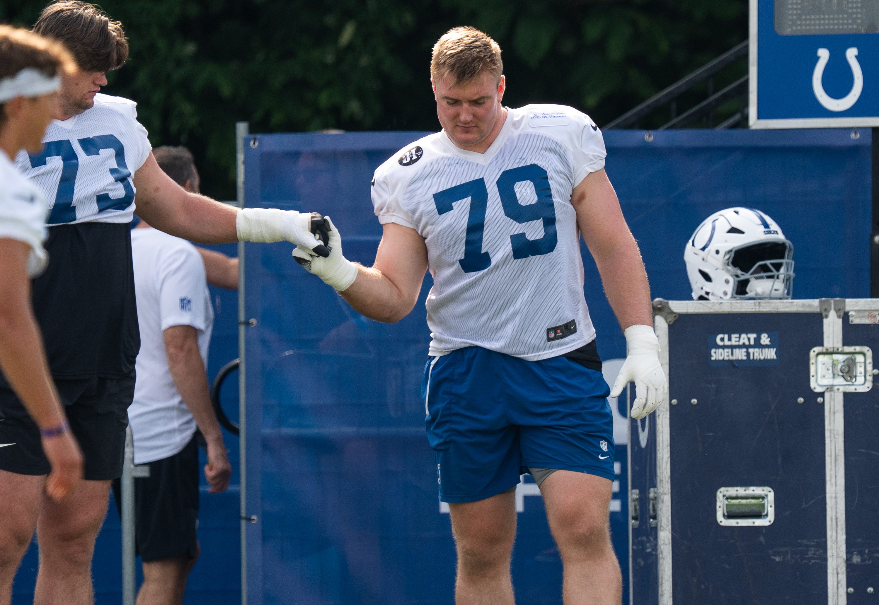 Indianapolis Colts offensive tackle Bernhard Raimann (79) gets a five from fellow offensive tackle Blake Freeland (73) on Friday, July 25, 2025, during training camp held at Grand Park in Westfield.