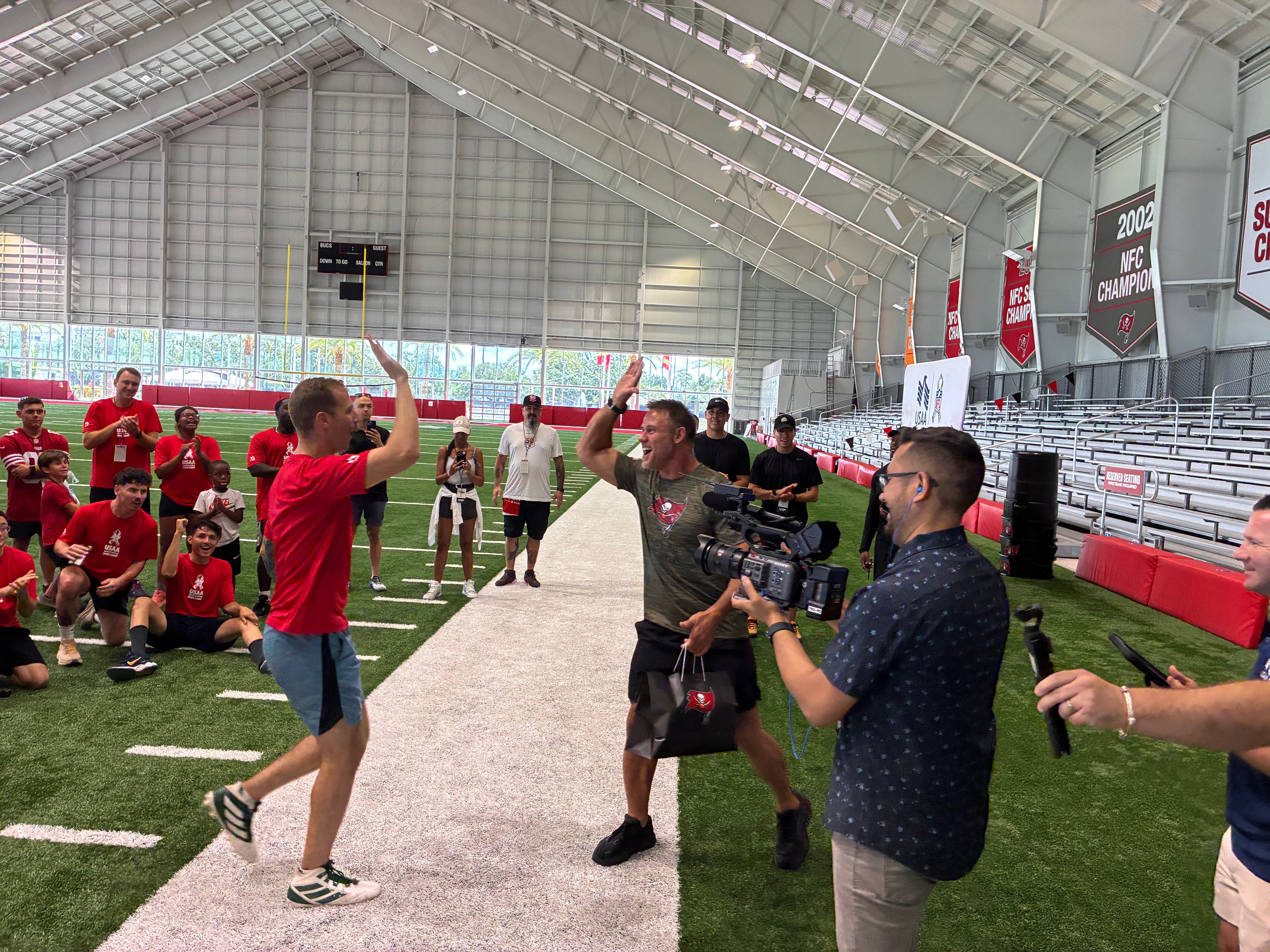 Mike Alstott high fives a service member after a successful drill.