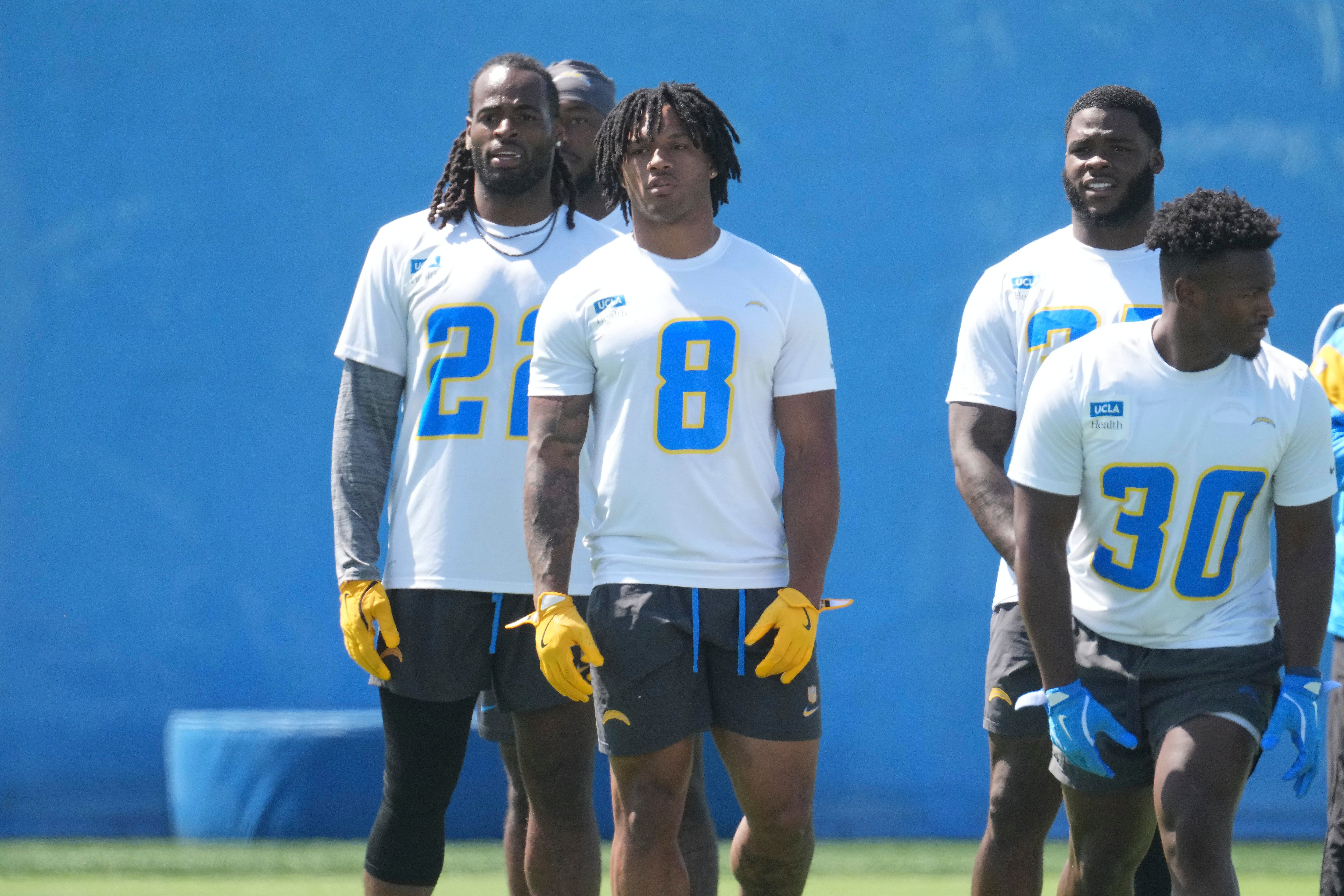 May 20, 2025; El Segundo, CA, USA; Los Angeles Chargers running backs Najee Harris (22), Omarion Hampton (8) and Kimani Vidal (30) look on during offseason workouts at The Bolt.