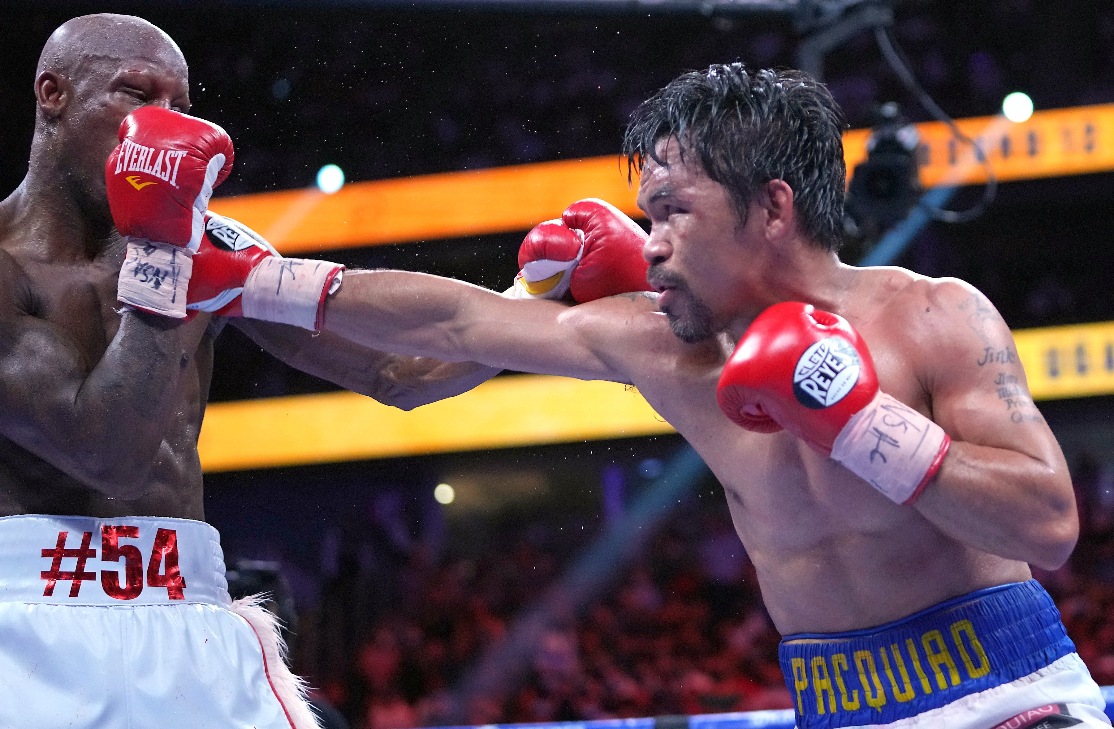 Aug 21, 2021; Las Vegas, Nevada; Manny Pacquiao (right) fights Yordenis Ugasin a world welterweight championship bout at T-Mobile Arena.