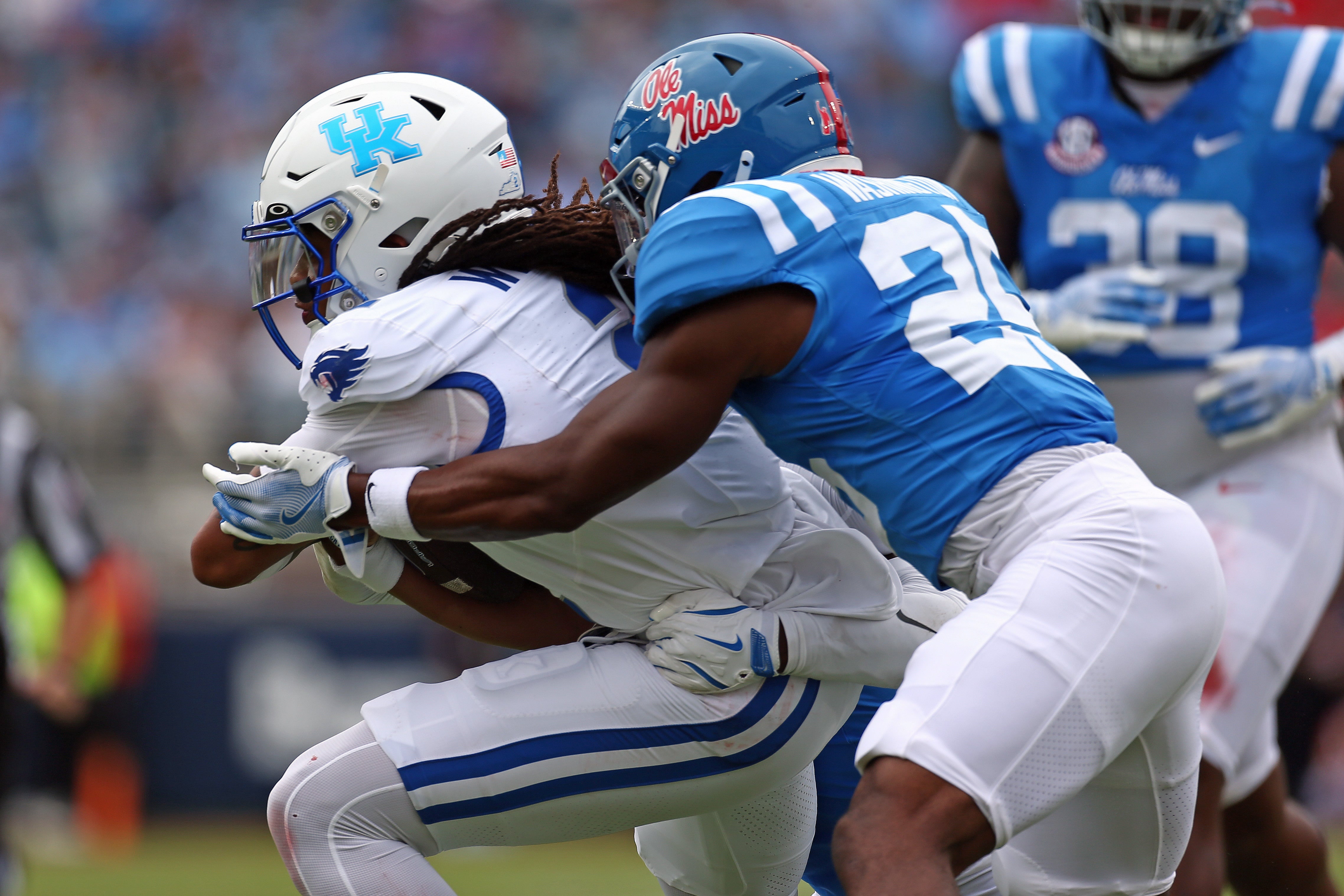 Sep 28, 2024; Oxford, Mississippi, USA; Kentucky Wildcats quarterback Gavin Wimsatt (2) runs the ball as Mississippi Rebels defensive back Trey Washington (25) makes the tackle during the first half at Vaught-Hemingway Stadium.