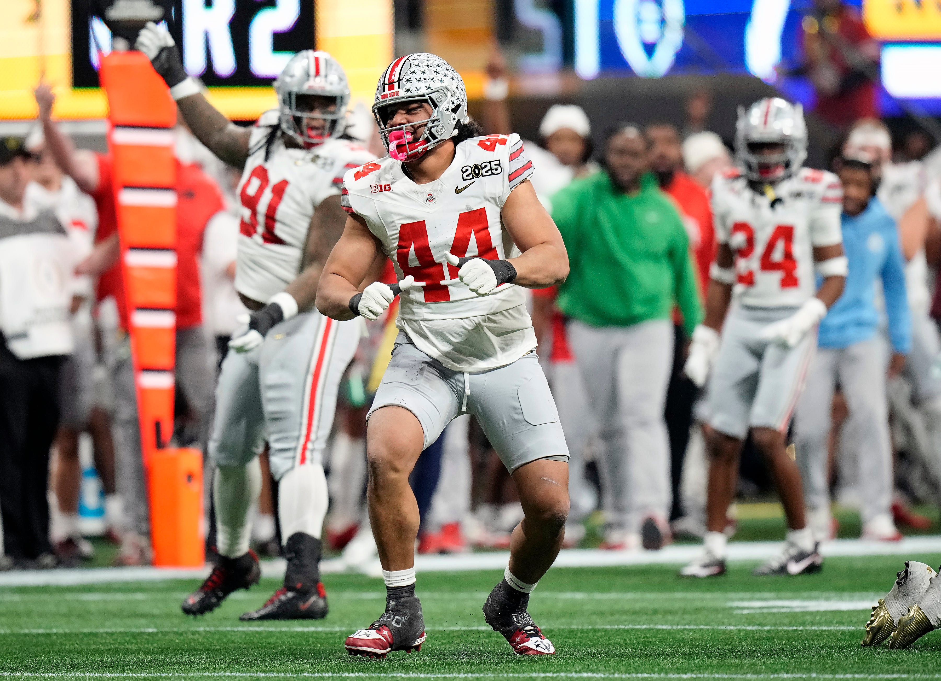 Ohio State Buckeyes defensive end JT Tuimoloau (44) celebrates a tackle against Notre Dame Fighting Irish in the second quarter during the College Football Playoff championship at Mercedes-Benz Stadium in Atlanta on January 20, 2025.