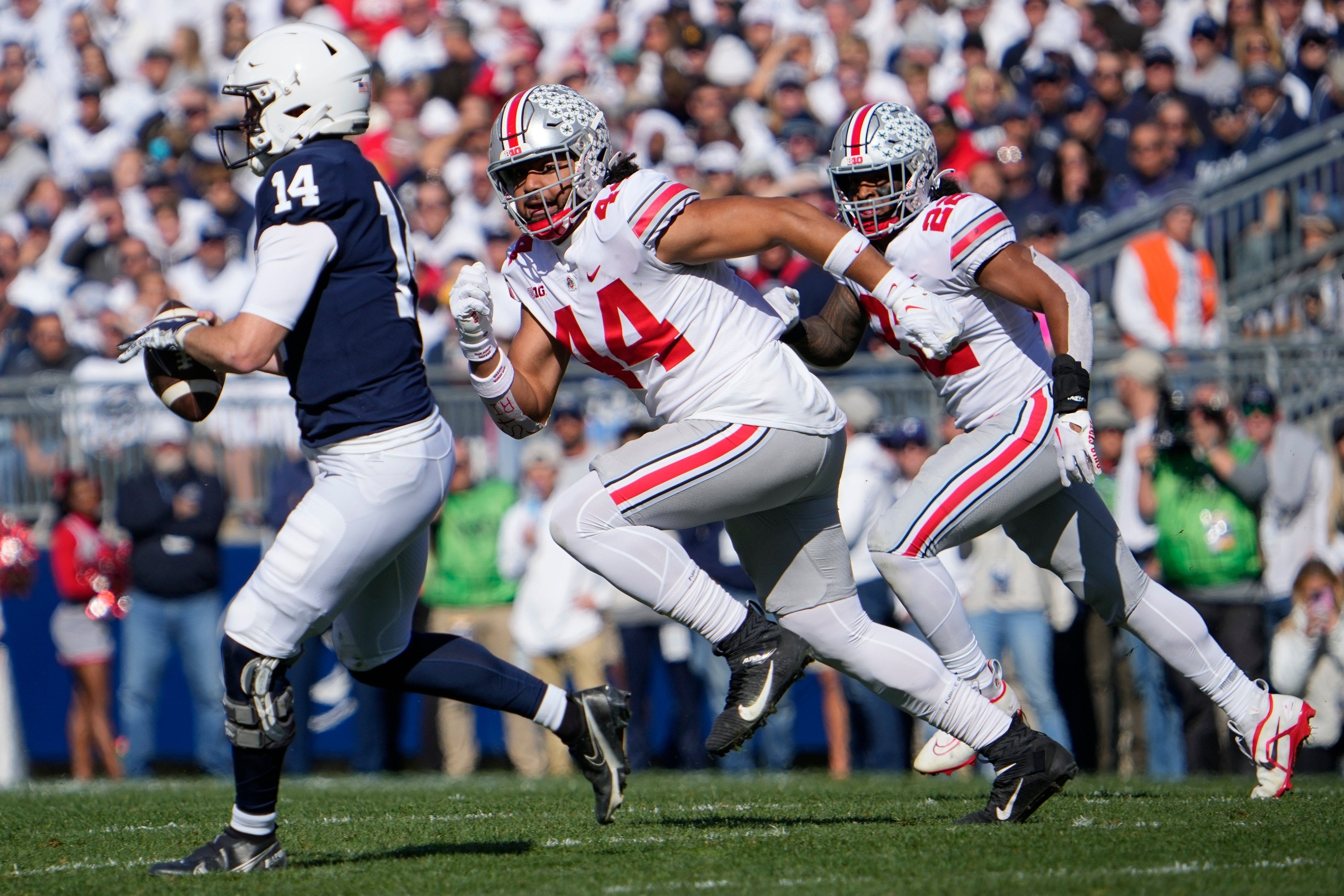 Oct 29, 2022; University Park, Pennsylvania, USA; Ohio State Buckeyes defensive end J.T. Tuimoloau (44) pursues Penn State Nittany Lions quarterback Sean Clifford (14) during the first half of the NCAA Division I football game at Beaver Stadium.