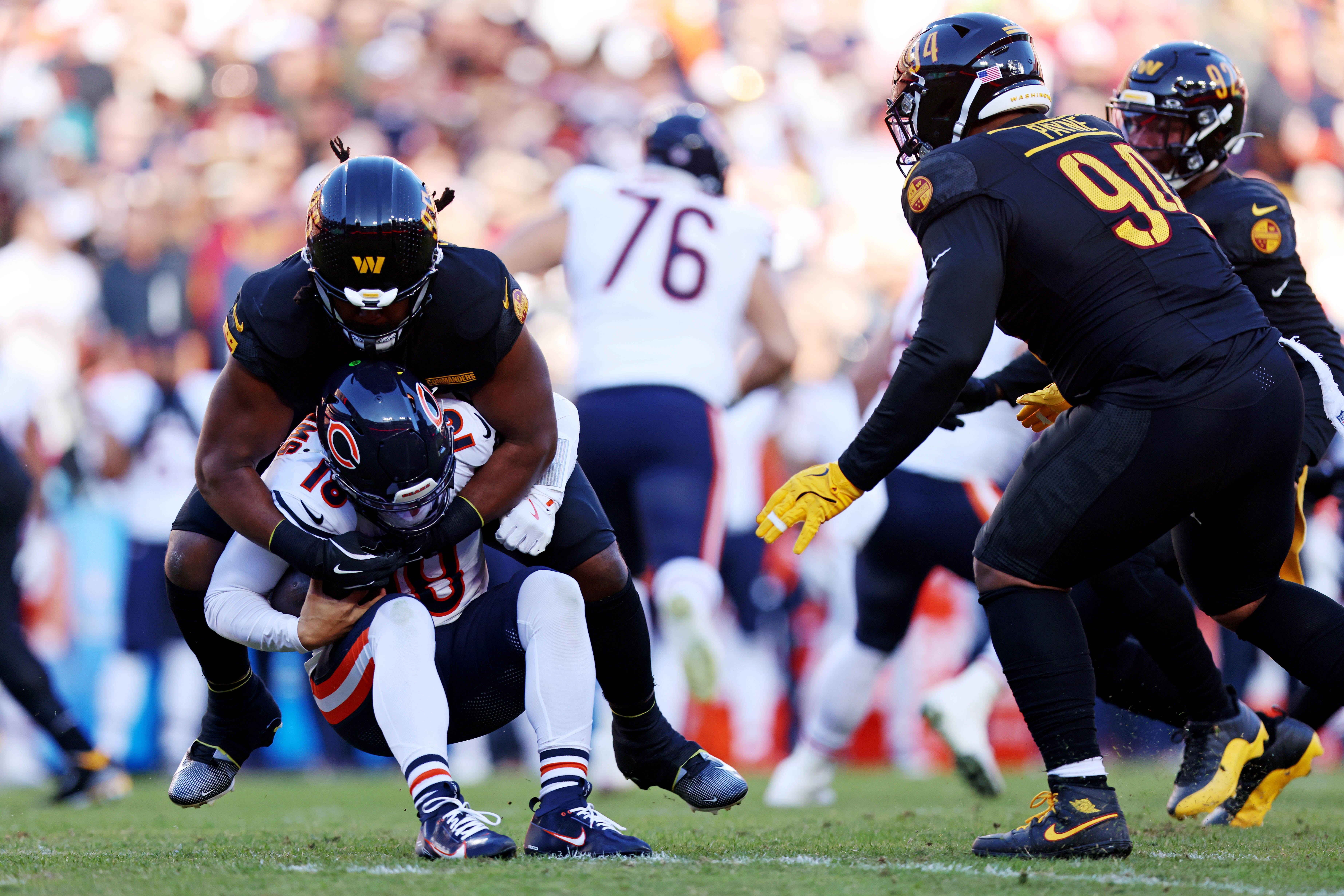 Oct 27, 2024; Landover, Maryland, USA; Washington Commanders defensive tackle Jer'Zhan Newton (95) sacks Chicago Bears quarterback Caleb Williams (18) during the first quarter at Commanders Field.