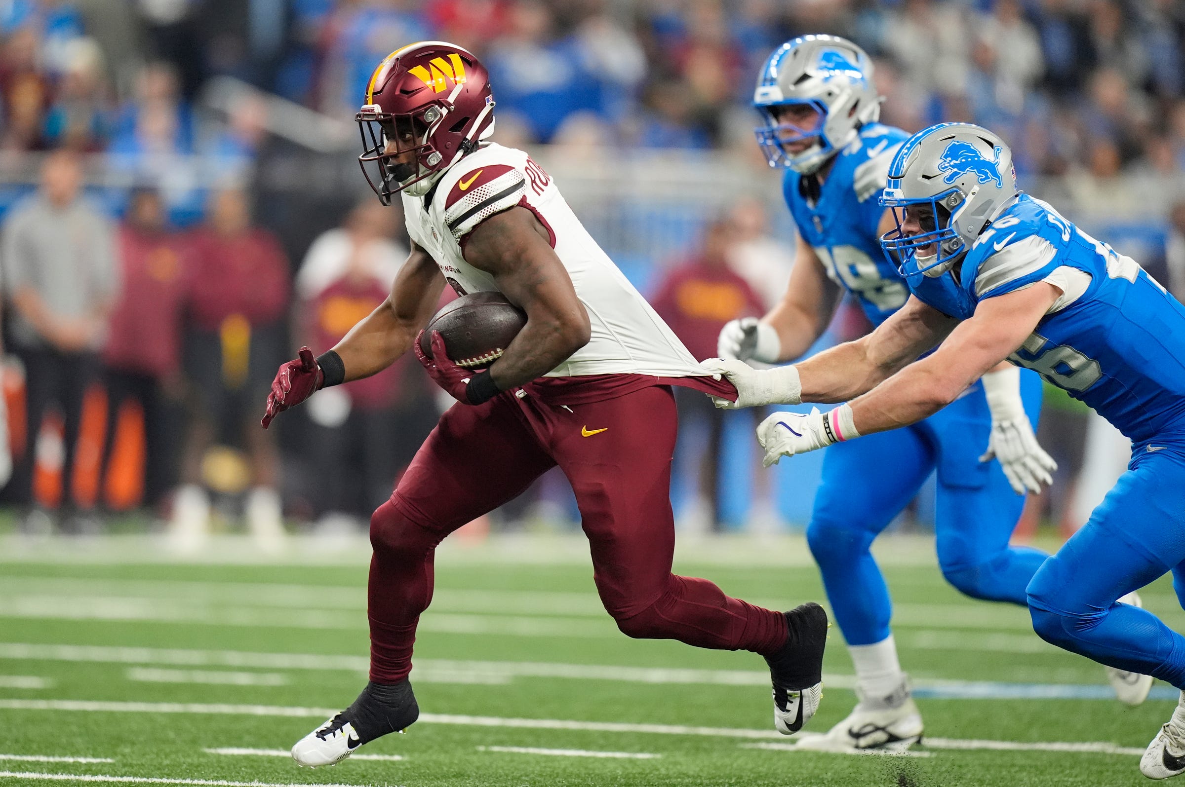  Detroit Lions linebacker Jack Campbell (46) attempts to stop Washington Commanders running back Brian Robinson Jr. (8) as he runs the ball in the first quarter in the NFC divisional round at Ford Field in Detroit on Saturday, Jan. 18, 2025.