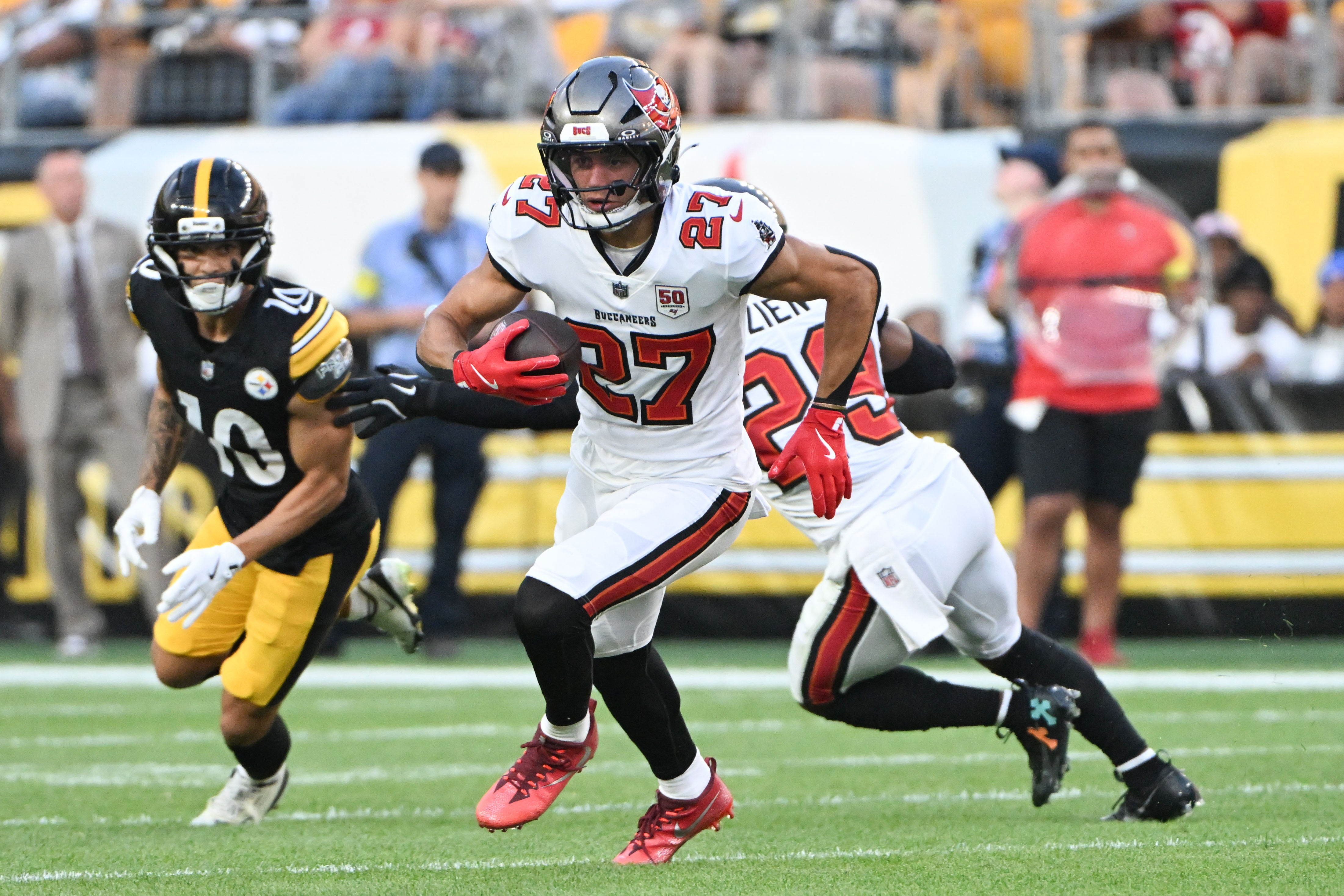 Aug 16, 2025; Pittsburgh, Pennsylvania, USA; Tampa Bay Buccaneers cornerback Zyon McCollum (27) returns an interception against the Pittsburgh Steelers during the first quarter at Acrisure Stadium.