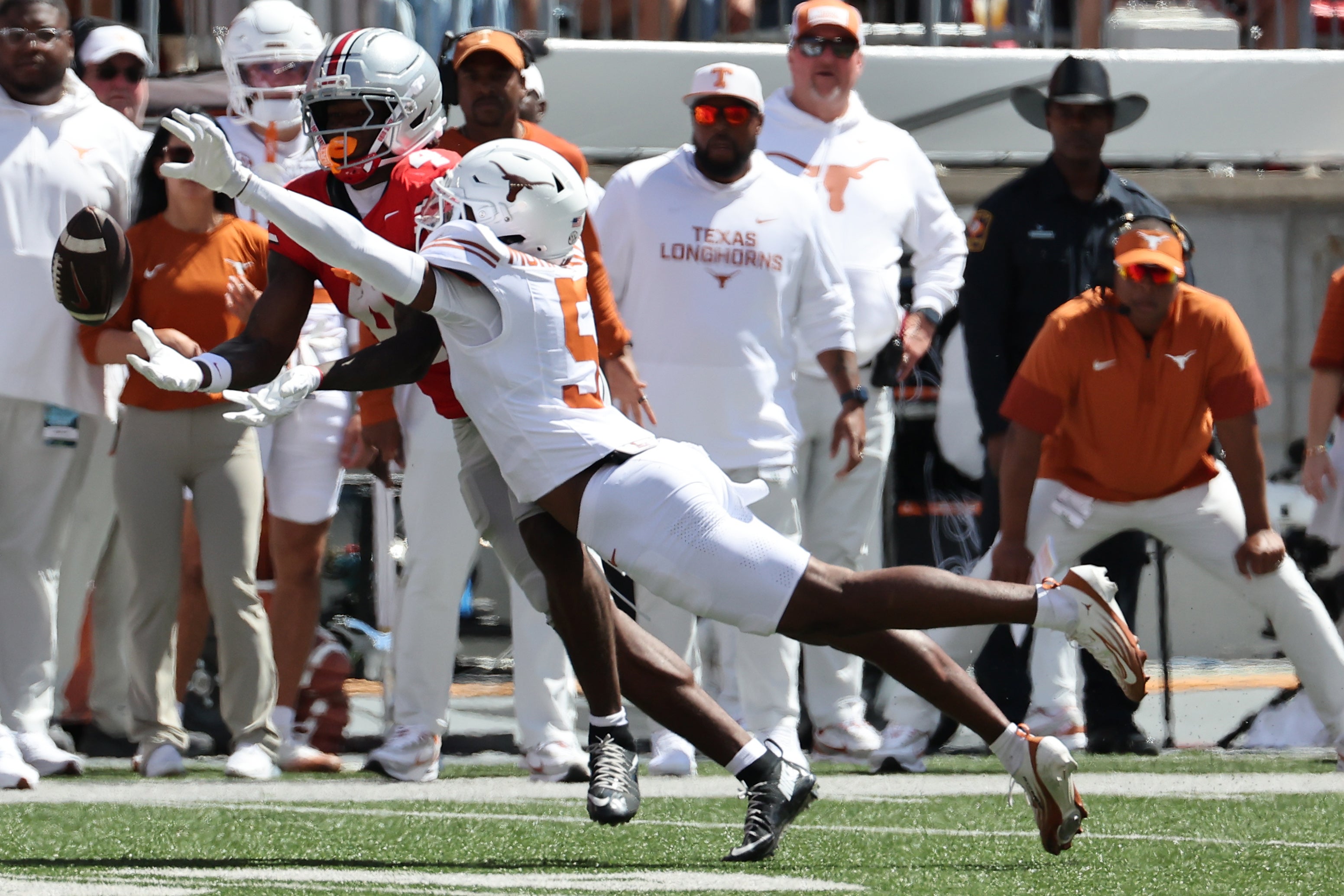Aug 30, 2025; Columbus, Ohio, USA; Ohio State Buckeyes wide receiver Jeremiah Smith (4) makes a catch over Texas Longhorns defensive back Malik Muhammad (5) in the first half at Ohio Stadium.