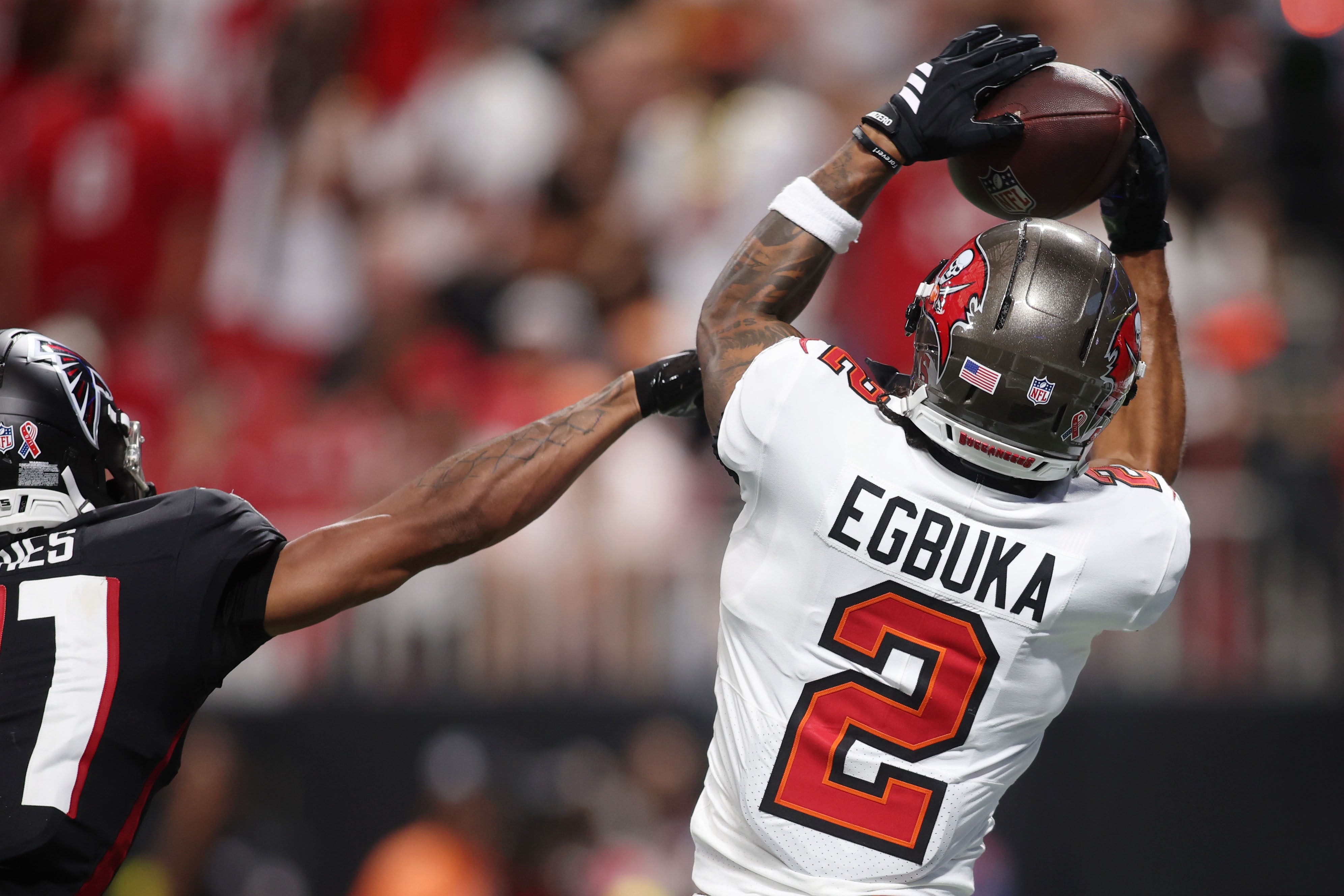 Sep 7, 2025; Atlanta, Georgia, USA; Tampa Bay Buccaneers wide receiver Emeka Egbuka (2) makes a catch against Atlanta Falcons cornerback Mike Hughes (21) for a touchdown during the fourth quarter at Mercedes-Benz Stadium.