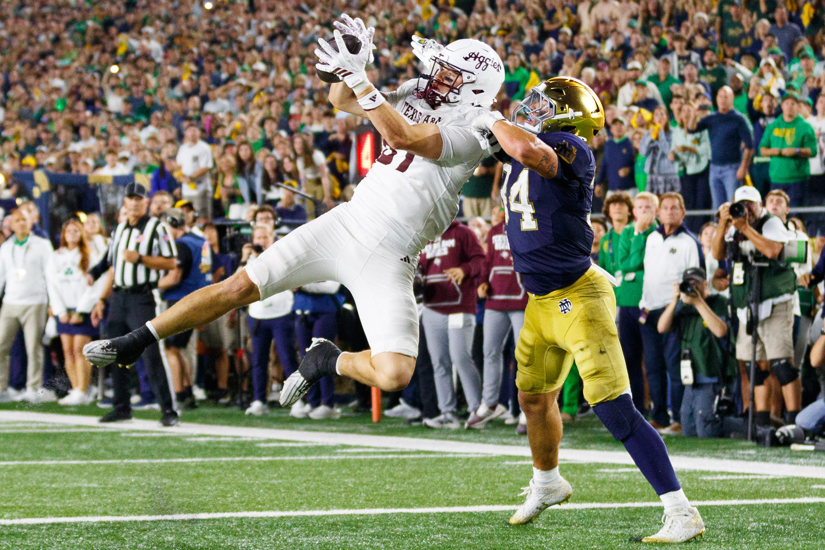 Texas A&M tight end Nate Boerkircher, left, catches a pass in the end zone to tie the game with Notre Dame linebacker Drayk Bowen, right, defending in the second half of a NCAA football game at Notre Dame Stadium on Saturday, Sept. 13, 2025, in South Bend. The extra point scored after this touchdown put Texas A&M ahead 41-40 to win the game.