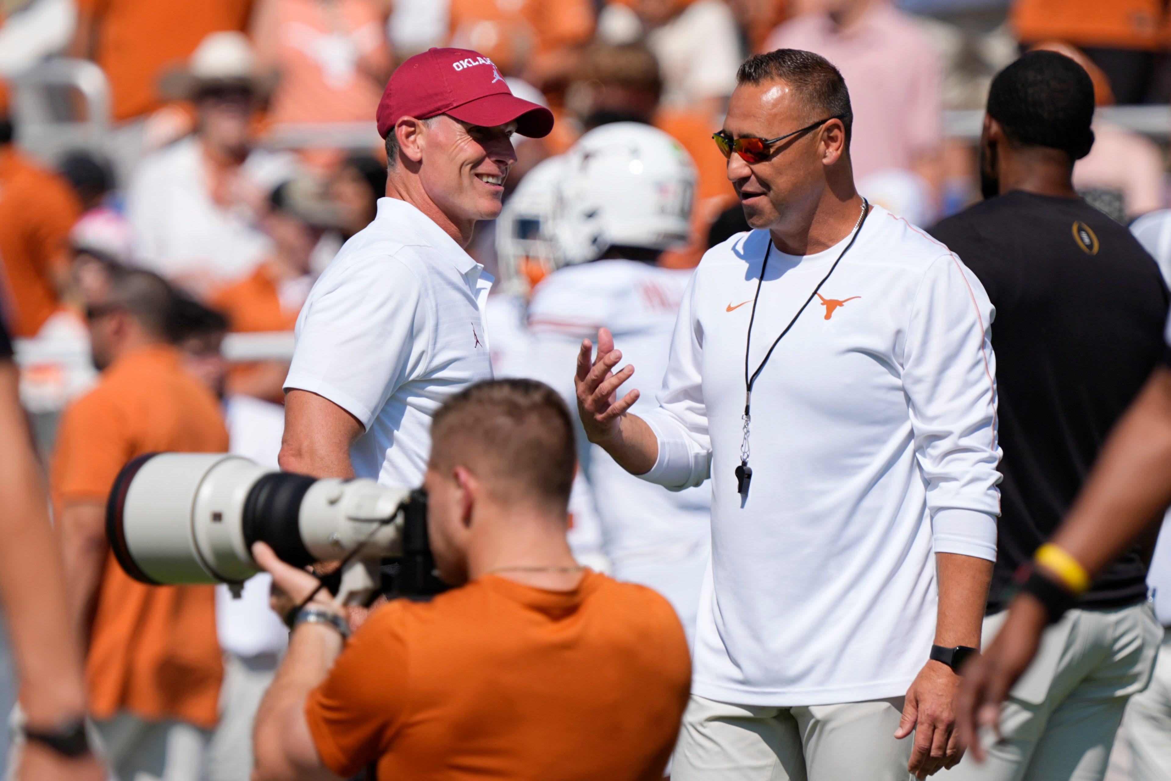 Texas head coach Steve Sarkisian speaks with Oklahoma head coach Brent Venables