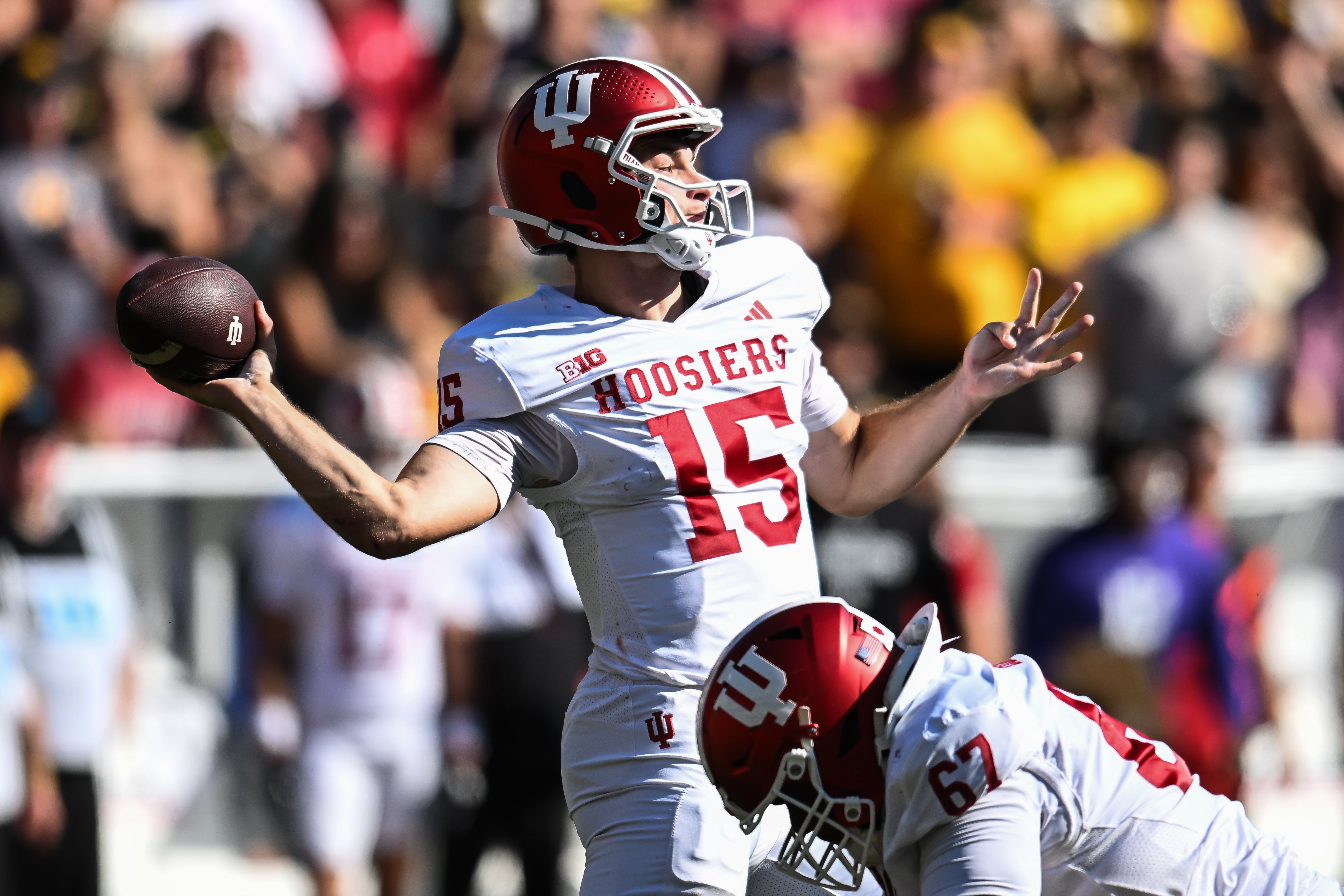 Sep 27, 2025; Iowa City, Iowa, USA; Indiana Hoosiers quarterback Fernando Mendoza (15) throws a pass against the Iowa Hawkeyes during the second quarter at Kinnick Stadium.
