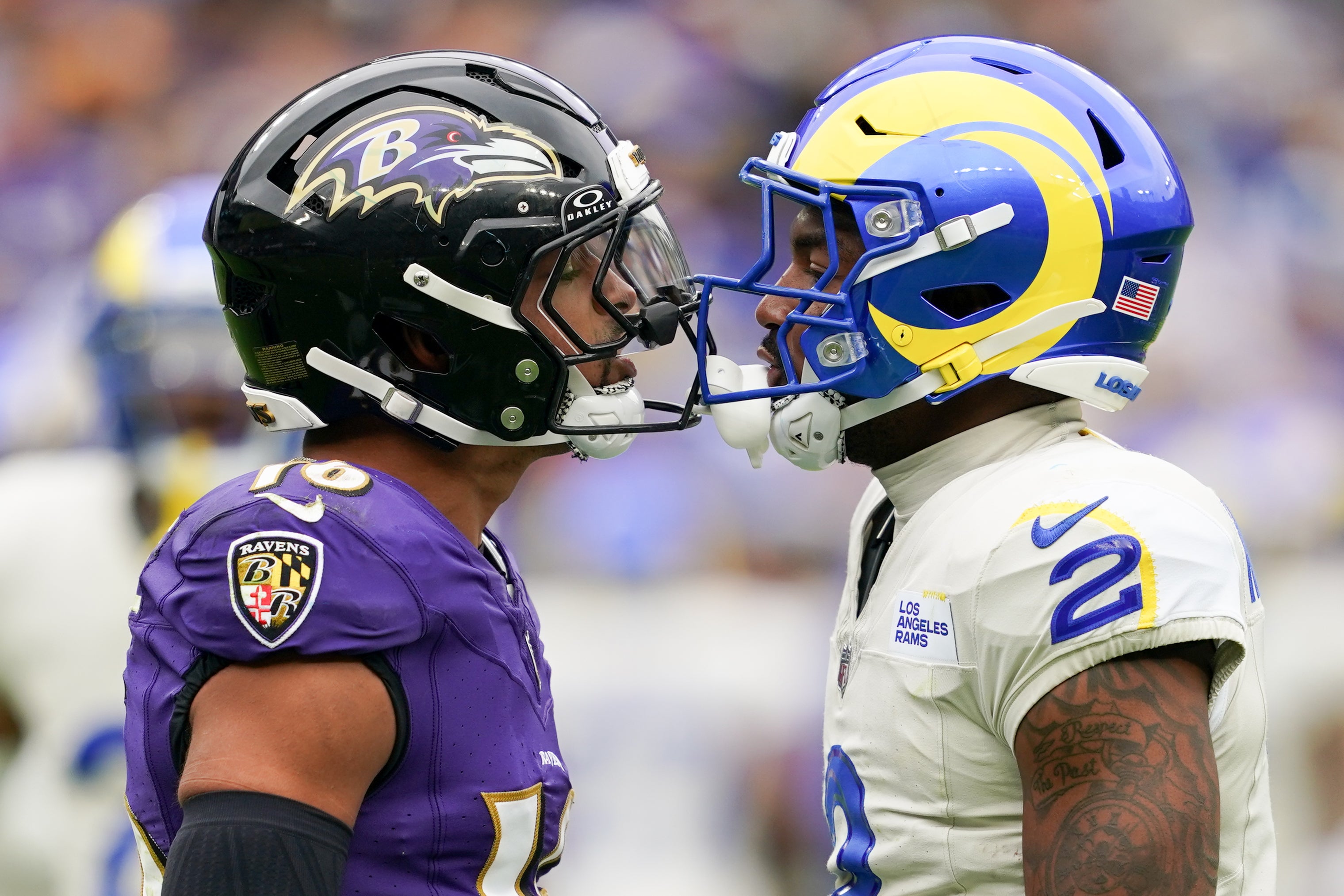 Oct 12, 2025; Baltimore, Maryland, USA; Baltimore Ravens wide receiver Tylan Wallace (16) and Los Angeles Rams safety Jaylen McCollough (2) talk during the second quarter of the game at M&T Bank Stadium.