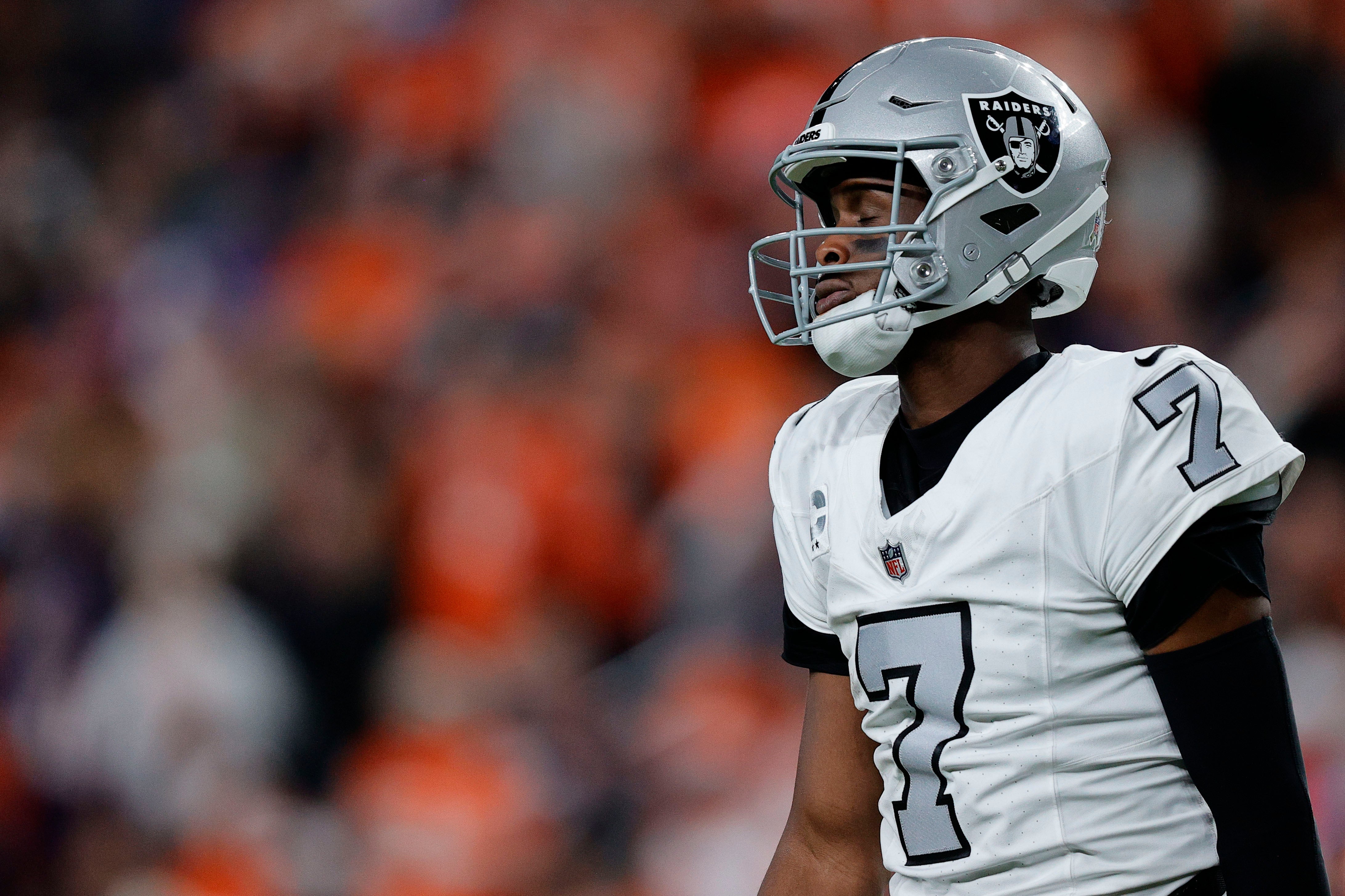 Nov 6, 2025; Denver, Colorado, USA; Las Vegas Raiders quarterback Geno Smith (7) reacts during the first half at Empower Field at Mile High. Mandatory Credit: Isaiah J. Downing-Imagn Images