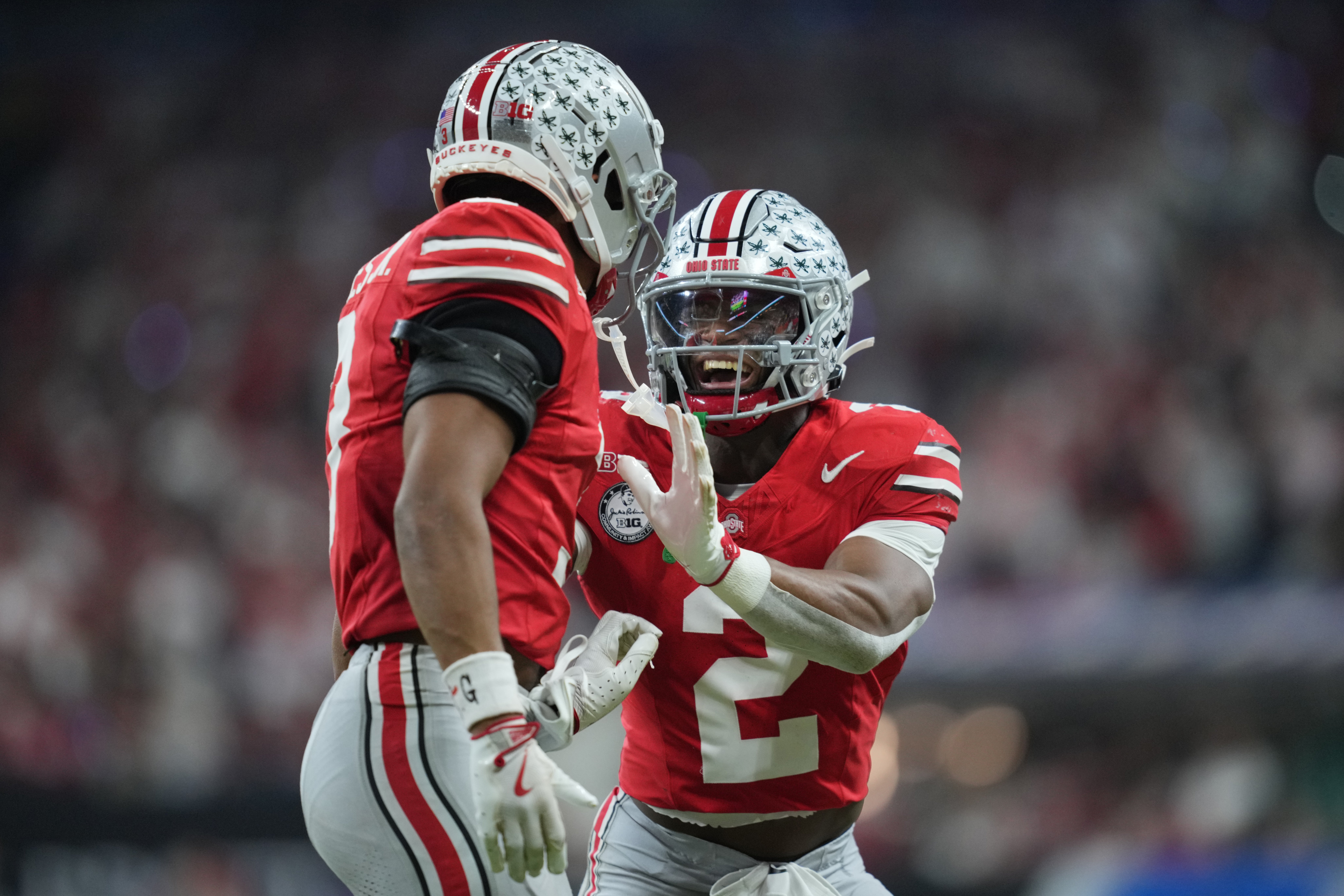 Dec 6, 2025; Indianapolis, IN, USA; Ohio State Buckeyes safety Caleb Downs (2) and cornerback Lorenzo Styles Jr. (3) react in the first half against the Indiana Hoosiers during the 2025 Big Ten championship game at Lucas Oil Stadium.