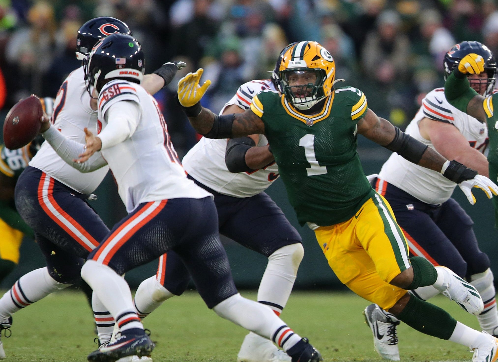 Micah Parsons (1) pressures Caleb Williams (18) on Sunday, December 7, 2025, at Lambeau Field in Green Bay, Wis.