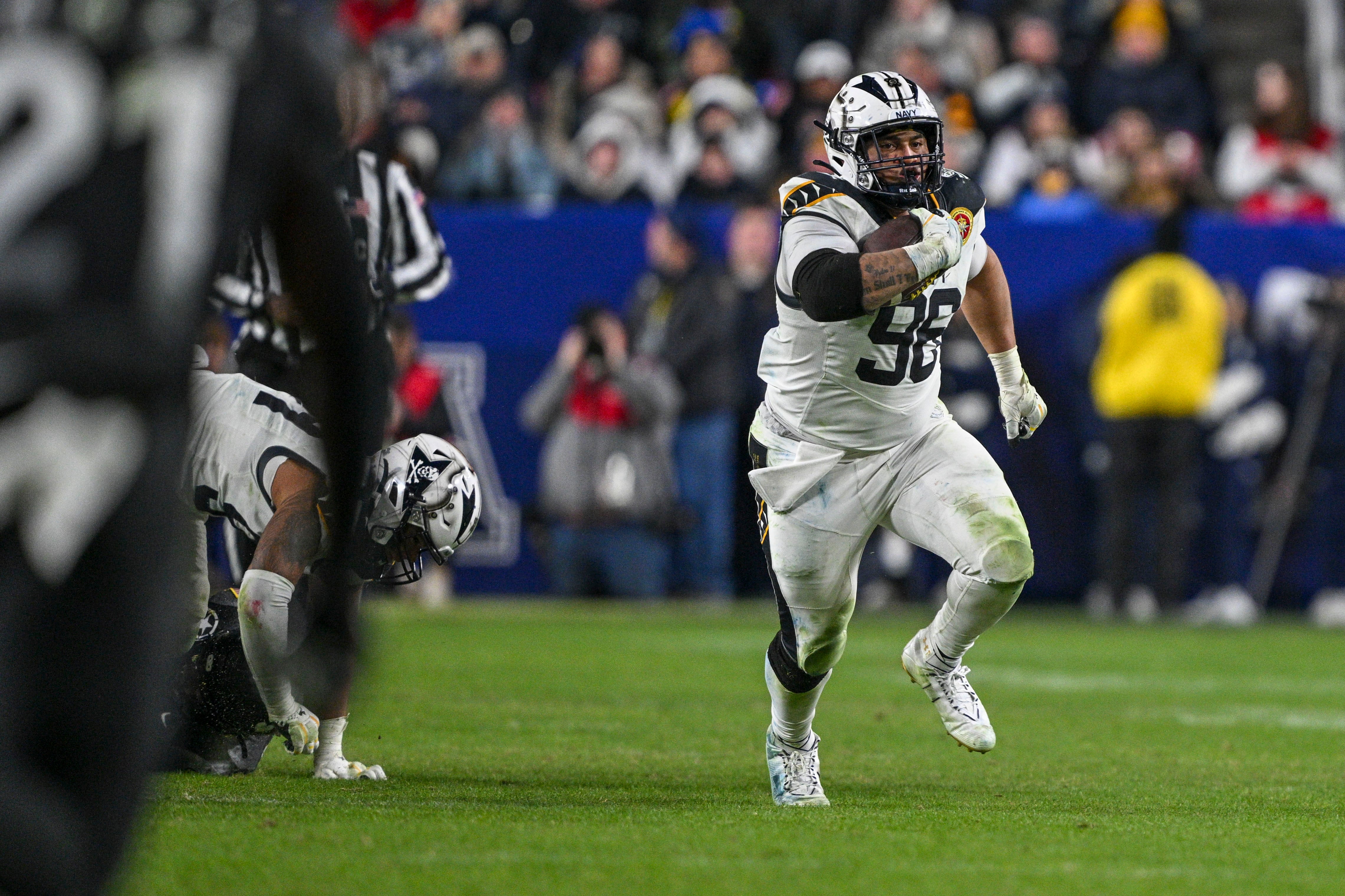 Dec 14, 2024; Landover, Maryland, USA; Navy Midshipmen defensive tackle Landon Robinson (96) runs on na fake punt during the second half against the Army Black Knights at Commanders Field.