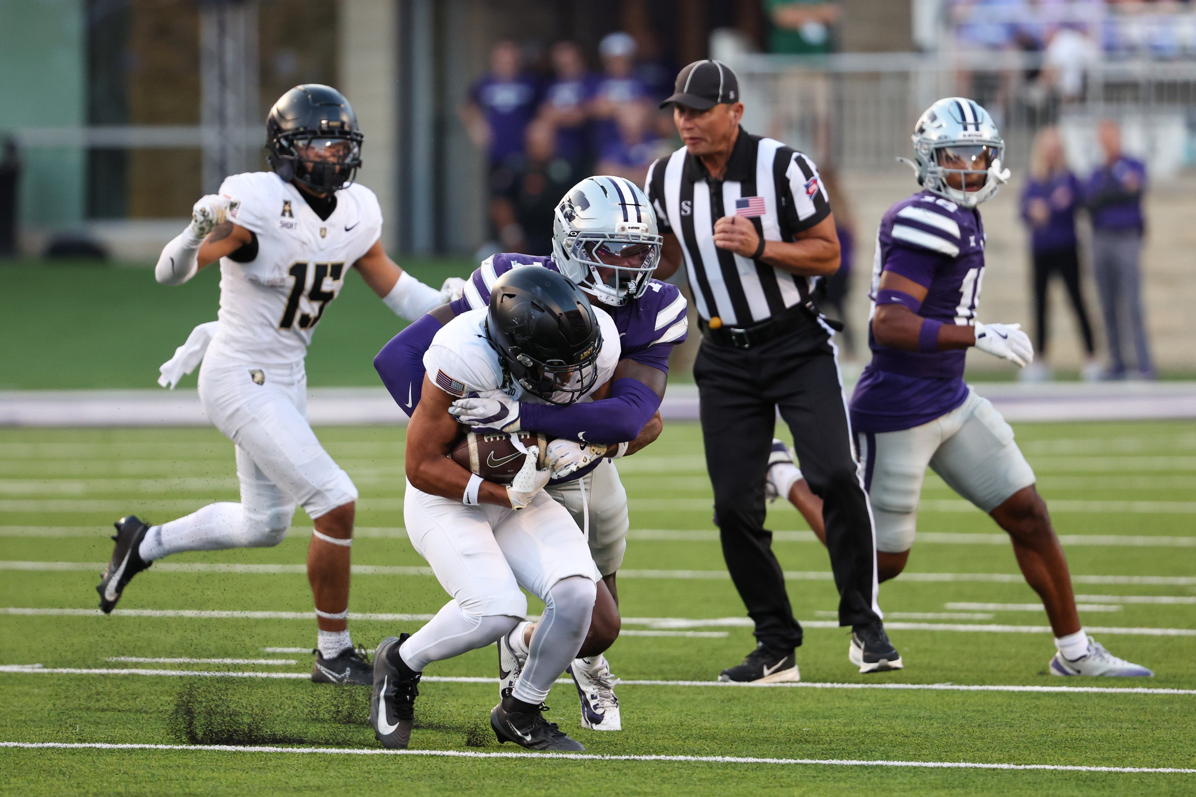 Sep 6, 2025; Manhattan, Kansas, USA; Army Black Knights wide receiver Samari Howard (27) is tackled by Kansas State Wildcats safety VJ Payne (7) during the third quarter at Bill Snyder Family Football Stadium.