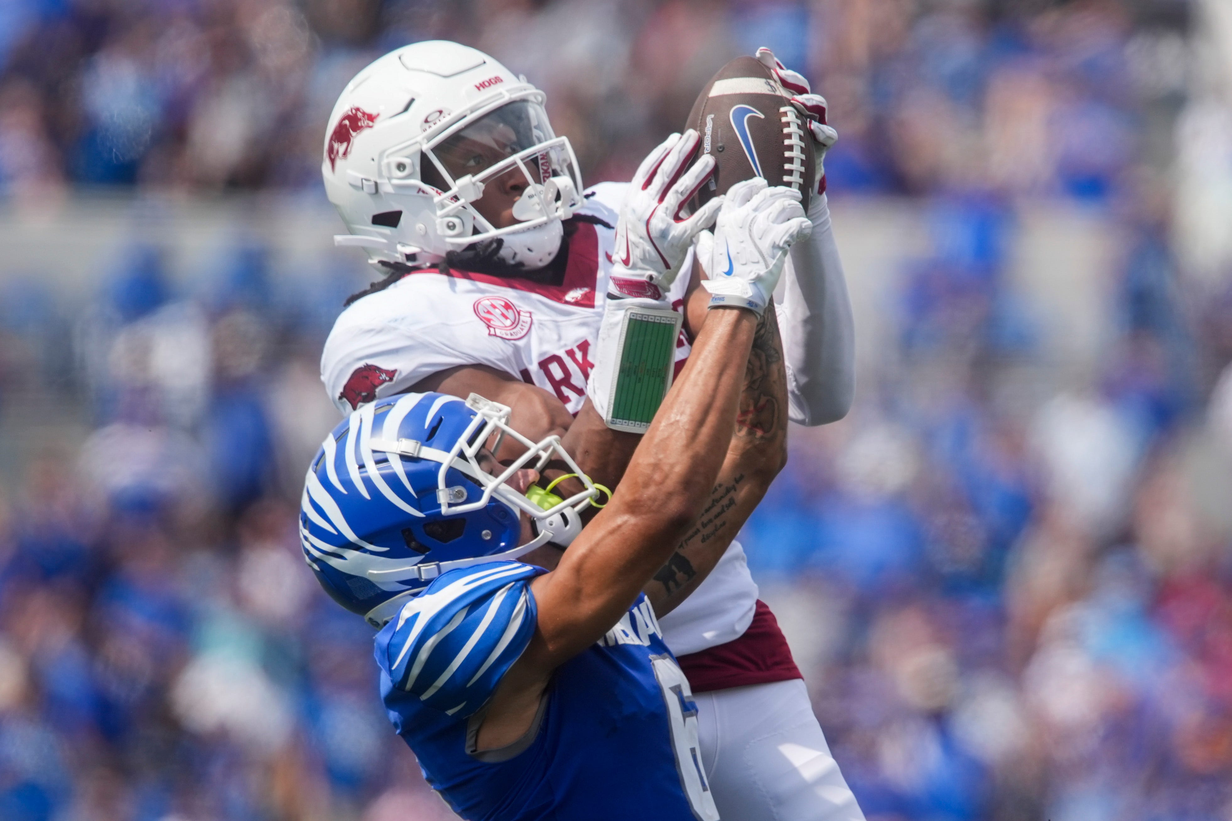 Memphis' Marcello Bussey (6) has the ball pulled out of his hands by Arkansas' Julian Neal (23) during the game between Memphis and Arkansas at Simmons Bank Liberty Stadium in Memphis, Tenn., on September 20, 2025.