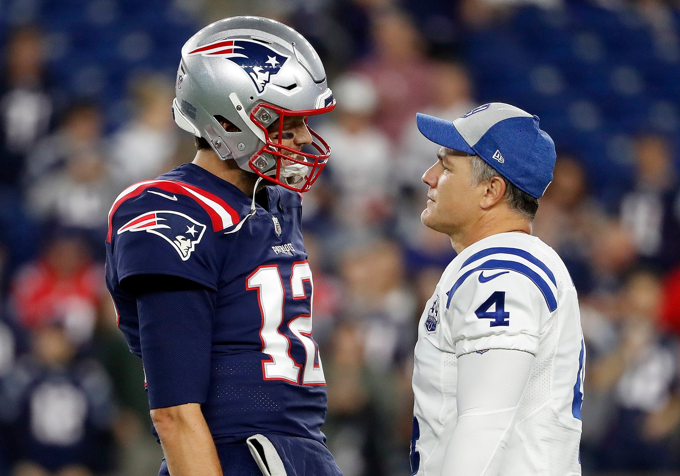 Former Colts kicker Adam Vinatieri talking with his former Patriots teammate Tom Brady