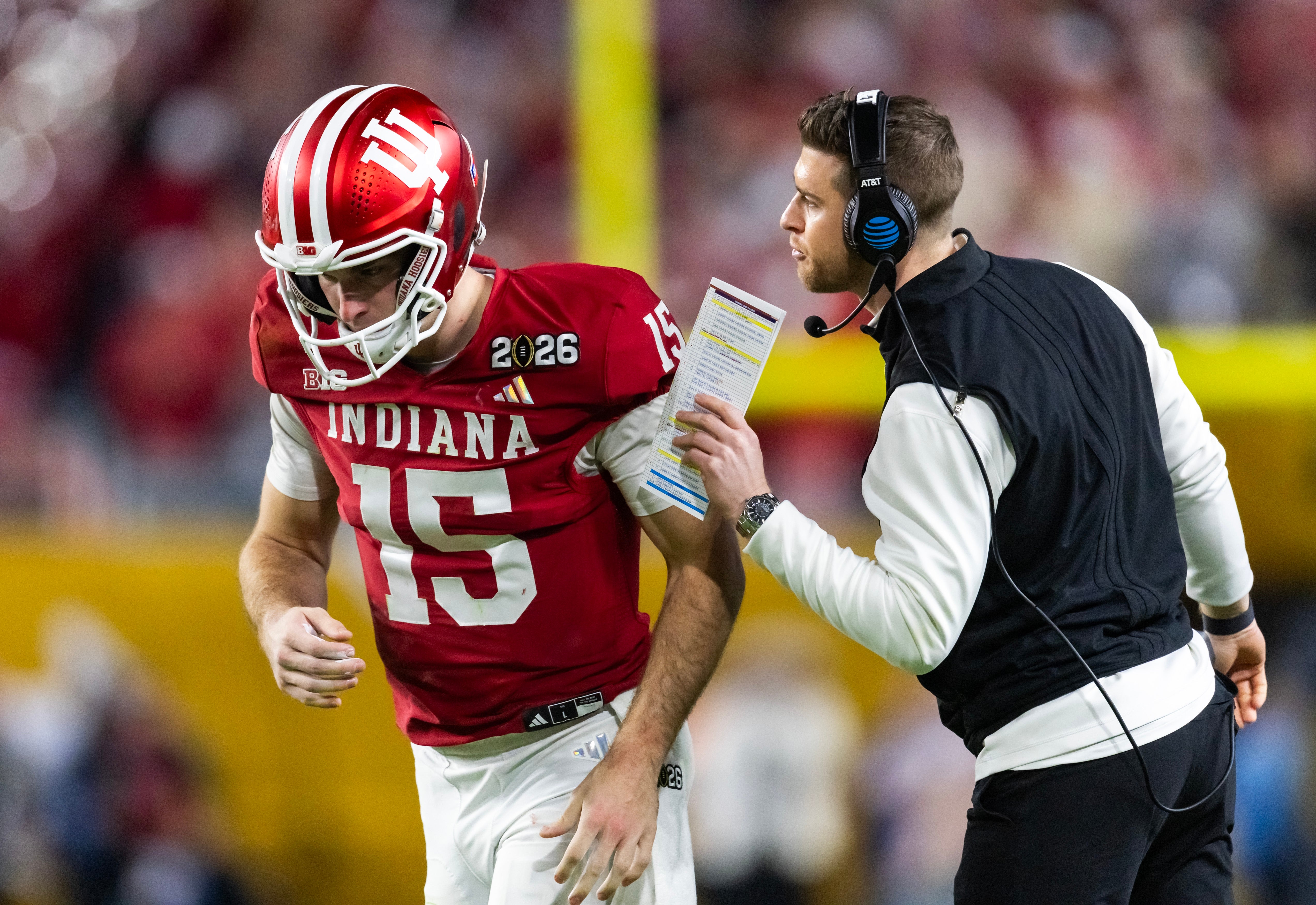 Jan 19, 2026; Miami Gardens, FL, USA; Indiana Hoosiers quarterback Fernando Mendoza (15) with quarterbacks coach Chandler Whitmer against the Miami Hurricanes in the College Football Playoff National Championship game at Hard Rock Stadium. 