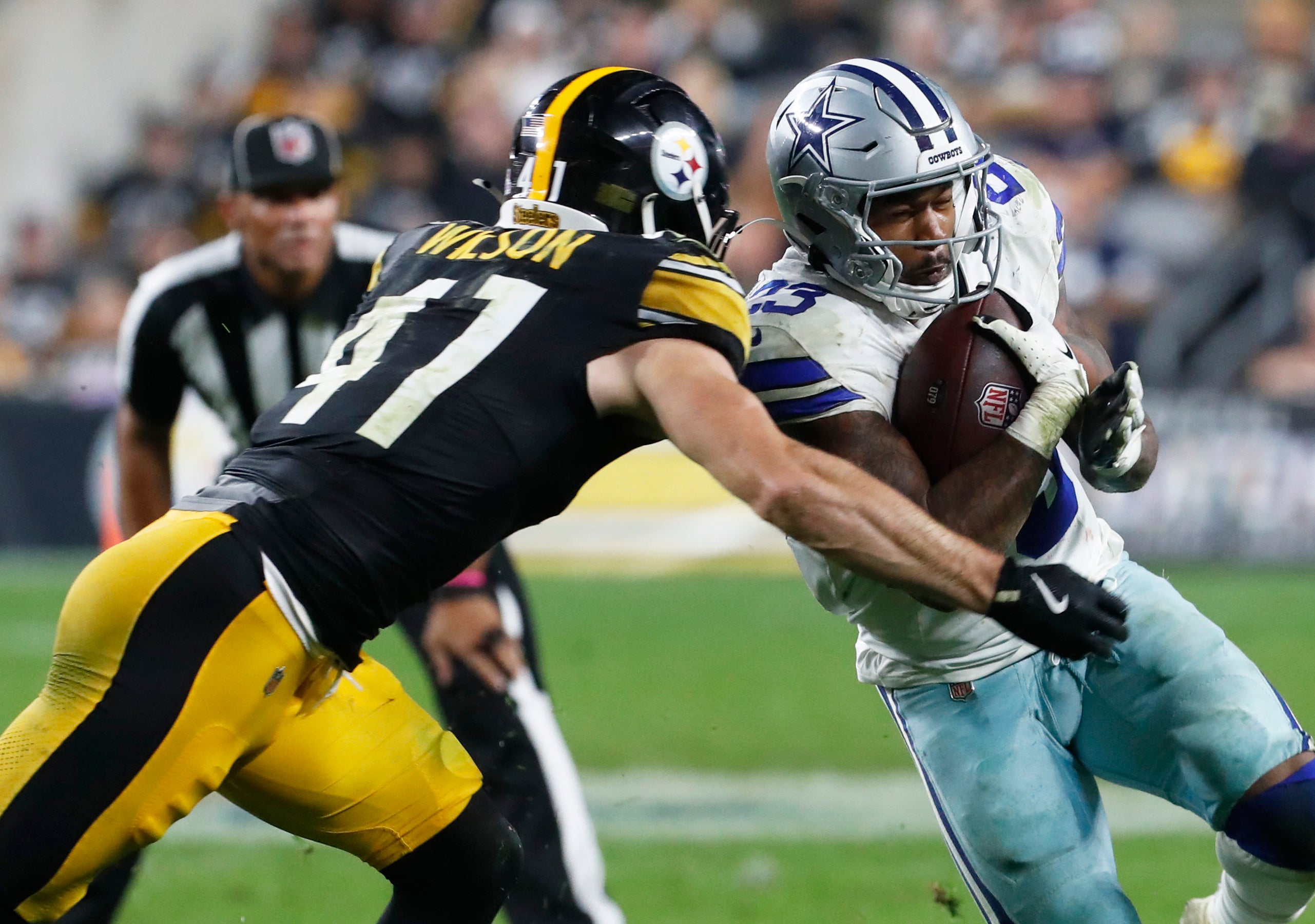 Oct 6, 2024; Pittsburgh, Pennsylvania, USA; Dallas Cowboys running back Rico Dowdle (23) runs the ball against Pittsburgh Steelers linebacker Payton Wilson (41) during the fourth quarter at Acrisure Stadium. Dallas won 20-17.