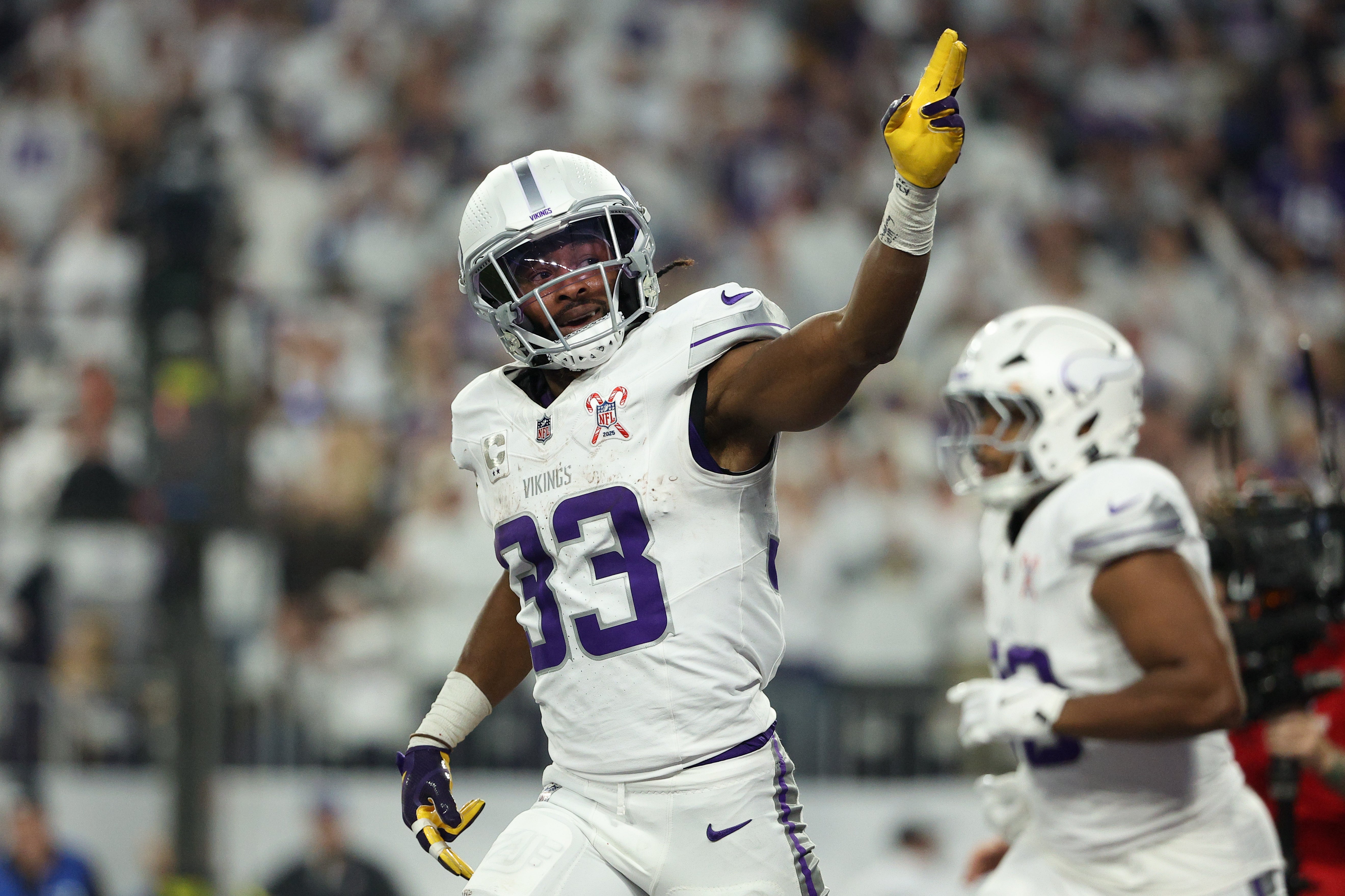 Dec 25, 2025; Minneapolis, Minnesota, USA; Minnesota Vikings running back Aaron Jones Sr. (33) celebrates after scoring a touchdown against the Detroit Lions in the first quarter at U.S. Bank Stadium.
