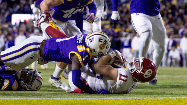 Nov 30, 2024; Baton Rouge, Louisiana, USA; Oklahoma Sooners quarterback Jackson Arnold (11) rushes against LSU Tigers safety Jardin Gilbert (2) and cornerback Ashton Stamps (1) during the second quarter at Tiger Stadium. 