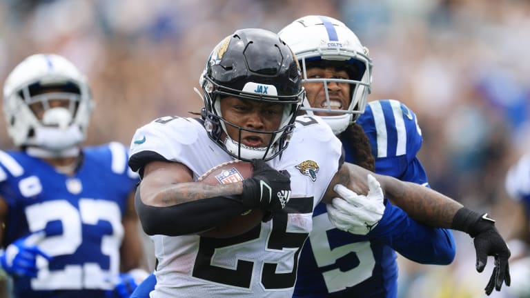 Jacksonville Jaguars running back James Robinson (30) slips past  Indianapolis Colts free safety …