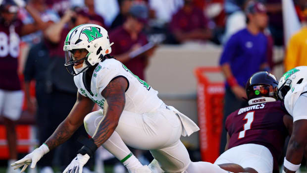 Marshall Thundering Herd defensive lineman Mike Green (15) celebrates after sacking Virginia Tech Hokies quarterback Kyron Drones (1) during the first quarter at Lane Stadium.