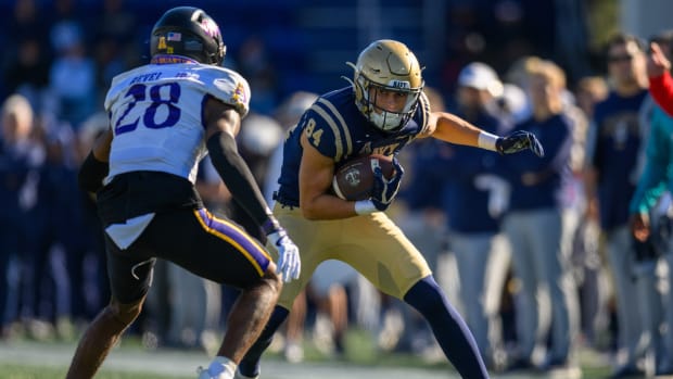 Nov 18, 2023; Annapolis, Maryland, USA; Navy Midshipmen wide receiver Regis Velez (84) runs the ball against East Carolina Pirates defensive back Shavon Revel (28) during the second quarter at Navy-Marine Corps Memorial Stadium.