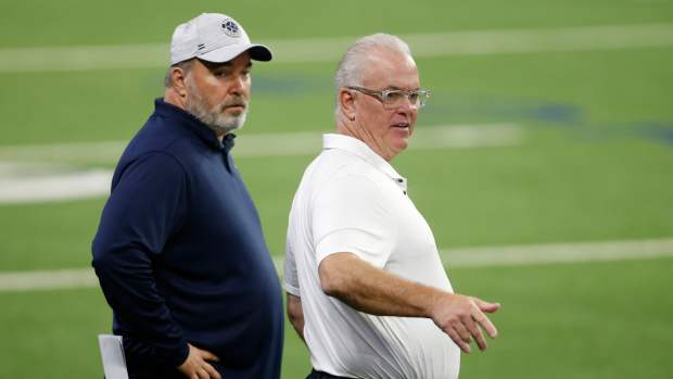 Dallas Cowboys head coach Mike McCarthy (L) and CEO Stephen Jones (R) on the field during minicamp at the Ford Center at the Star Training Facility in Frisco, Texas.