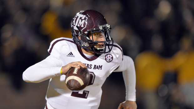 Texas A&M Aggies quarterback Johnny Manziel (2) scrambles to the outside against the Missouri Tigers during the first half at Faurot Field.