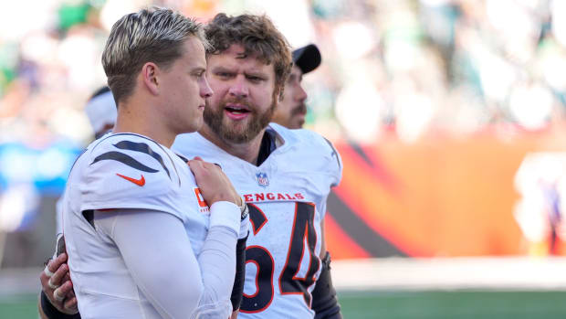 Cincinnati Bengals center Ted Karras (64) checks on quarterback Joe Burrow (9) after he leaves the game in the fourth quarter of the NFL Week 8 game between the Cincinnati Bengals and the Philadelphia Eagles at Paycor Stadium in downtown Cincinnati on Sunday, Oct. 27, 2024. The Bengals fell to 3-5 on the season with a 37-17 loss to the Eagles at home.  