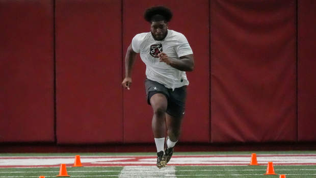 Offensive lineman Tyler Booker runs the 40 yard dash at the University of Alabama Pro Day as several Crimson Tide players worked out for NFL teams in the Hank Crisp Indoor Practice Facility.