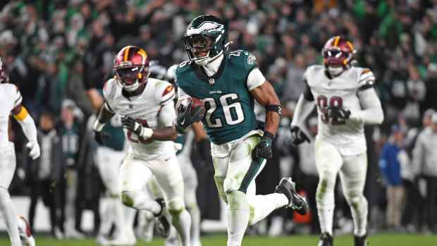 Philadelphia Eagles running back Saquon Barkley (26) runs past Washington Commanders defenders on way to a 39-yard touchdown during the fourth quarter against the Washington Commanders