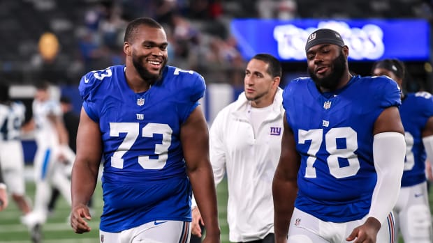 New York Giants tackle Evan Neal #73 walks off the field after their 31-27  loss to the New York Jets in an NFL pre-season football game, Sunday, Aug.  27, 2022, in East