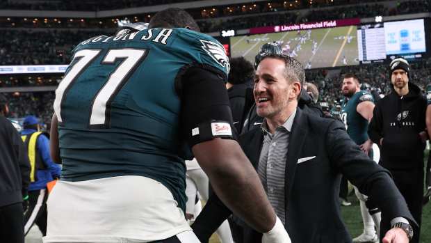 Philadelphia Eagles general manager Howie Roseman celebrates with Philadelphia Eagles offensive tackle Mekhi Becton (77) during the fourth quarter of the NFC Championship game against Washington.
