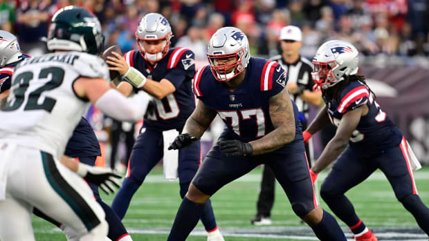 New England Patriots running back Ezekiel Elliott (15) hugs quarterback  Bailey Zappe (4) before a preseason NFL football game against the Green Bay  Packers, Saturday, Aug. 19, 2023, in Green Bay, Wis. (