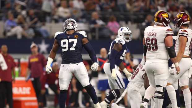 Dallas Cowboys defensive tackle Osa Odighizuwa (97) celebrates a sack in the second half against the Washington Commanders at AT&T Stadium.