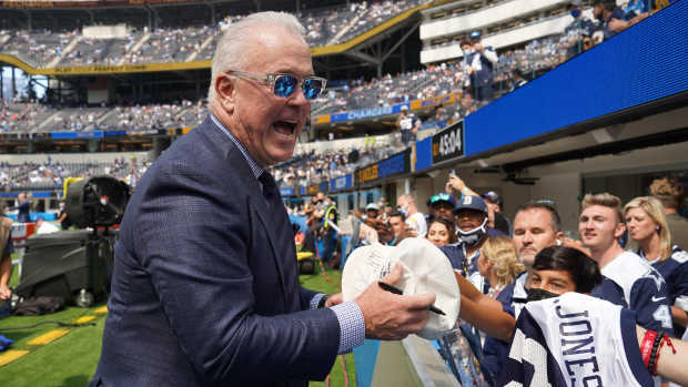 Dallas Cowboys executive vice president Stephen Jones signs autographs before the game against the Los Angeles Chargers at SoFi Stadium.