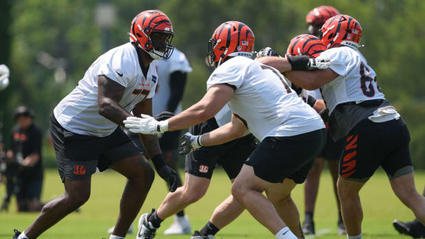 Jun 10, 2025; Cincinnati, OH, USA; Cincinnati Bengals offensive tackle Caleb Etienne (77) (left) blocks offensive tackle Devin Cochran (76) during practice at Paycor Stadium.