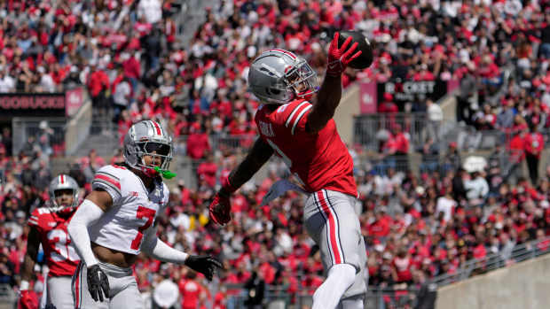 April 13, 2024; Columbus, Ohio, USA; Ohio State Buckeyes wide receiver Emeka Egbuka (2) catches a pass for the scarlet team while defended by cornerback Jordan Hancock (7) of the grey team during the first half of the LifeSports Spring Game at Ohio Stadium on Saturday.