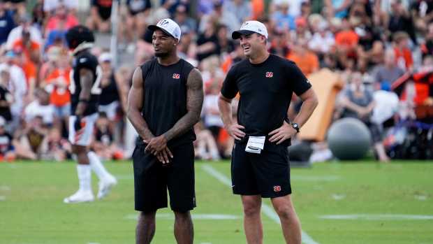 Cincinnati Bengals wide receiver Ja'Marr Chase (1) talks with head coach Zac Taylor on the sideline during a preseason training camp practice at the Paycor Stadium practice field in downtown Cincinnati on Wednesday, Aug. 7, 2024.  