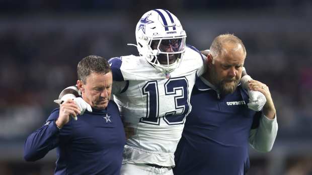 Dallas Cowboys linebacker DeMarvion Overshown (13) is helped off the field after an injury in the second half against the Cincinnati Bengals at AT&T Stadium.
