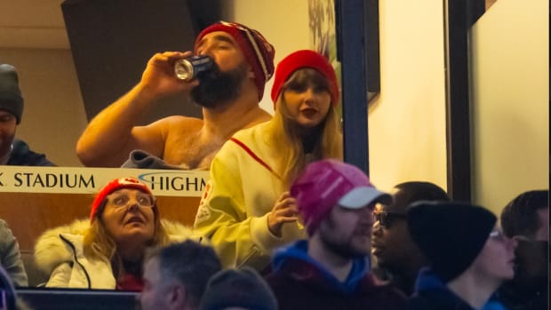 Taylor Swift watches the game as Jason Kelce drinks a beer during the Kansas City Chiefs game in the 2024 AFC divisional round game between against the Buffalo Bills at Highmark Stadium.