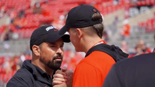 Nate Roberts, a 2025 tight end prospect out of Washington, Oklahoma, speaks with OSU coach Ryan Day prior to the Buckeyes' game against Western Kentucky on Sept. 16, 2023
