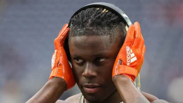 Cleveland Browns tight end David Njoku (85) listens to music on his Beat headphones while stretching before playing against the Houston Texans in a 2024 AFC wild card game at NRG Stadium.
