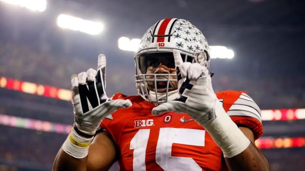 Ohio State Buckeyes running back Ezekiel Elliott (15) celebrates scoring a touchdown on a 33-yard run during the first quarter of the College Football Playoff National Championship against the Oregon ...